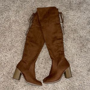 Brown lace up in the back knee high boots. Size 6.